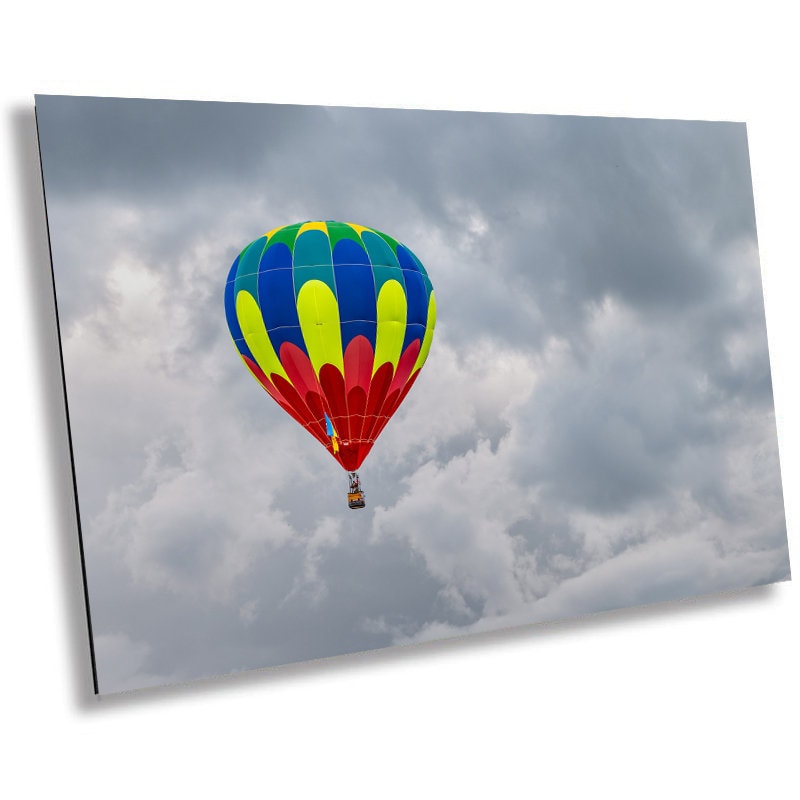 Vivid Balloon Against Dark Sky: A Colorful Hot Air Balloon Amidst Gray Clouds Wall Art Albuquerque Balloon Festival Metal Canvas Print