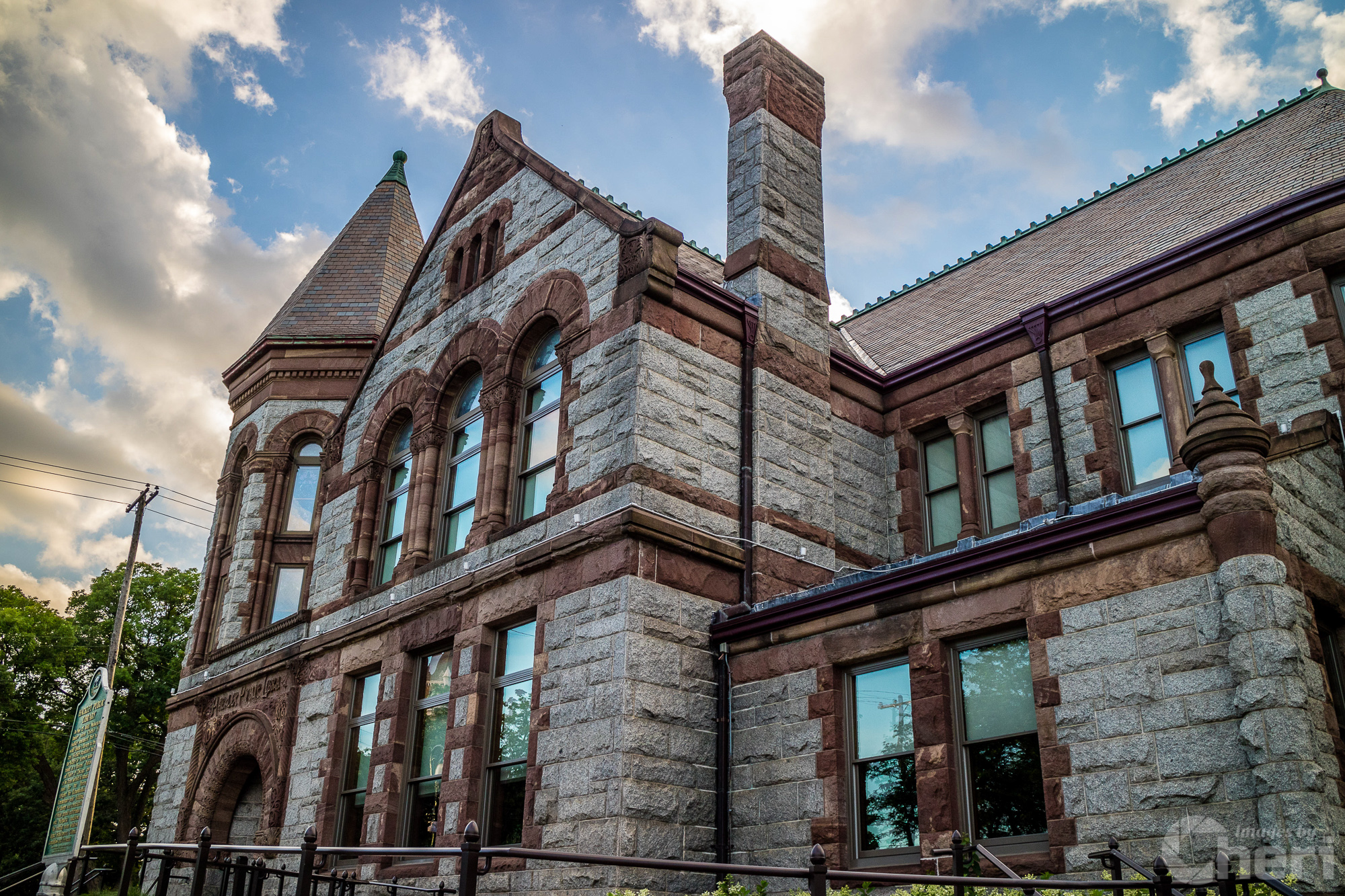 Bemidji State University ornate entrance arch with brick pillars at sunset.