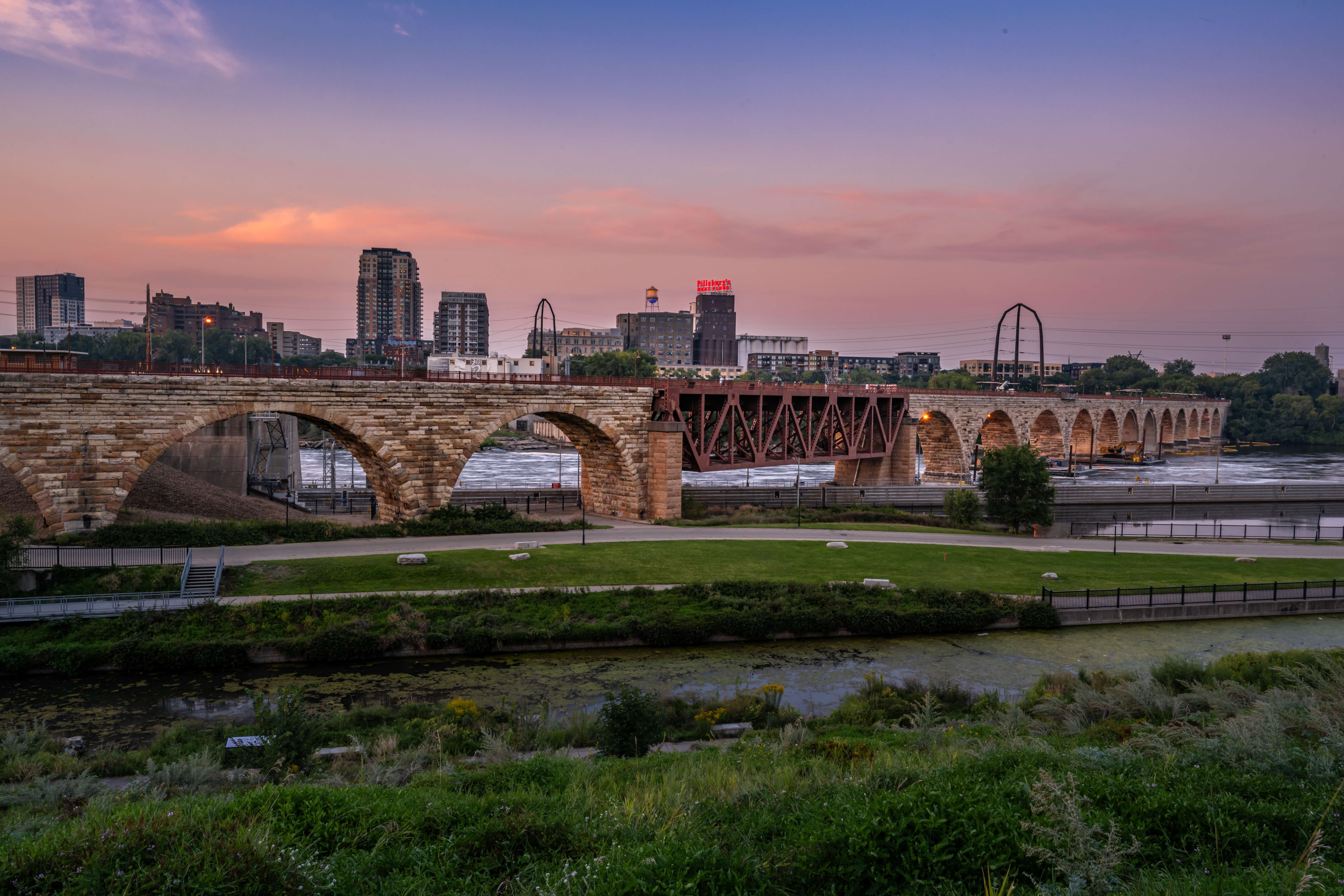 Majestic Minneapolis at Sunset: Stone Arch Bridge Over the Mississippi River Majestic Minneapolis at Sunset: Stone Arch Bridge Over the Mississippi River
