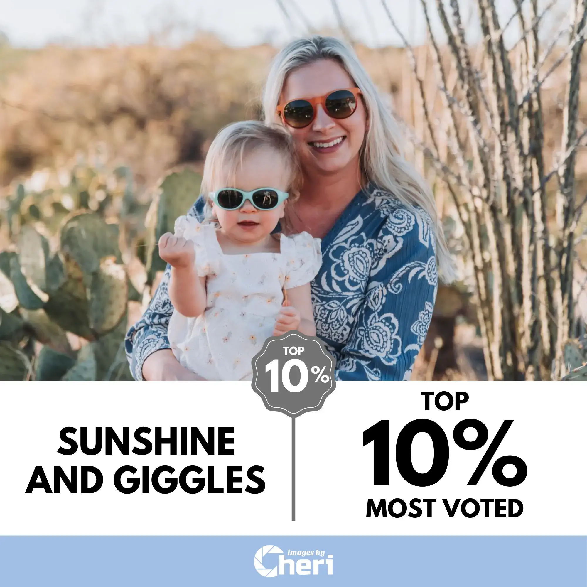 A smiling mother holding her baby, both wearing sunglasses, standing in a sunny desert landscape with cactus plants. Top 10% Most Voted.
